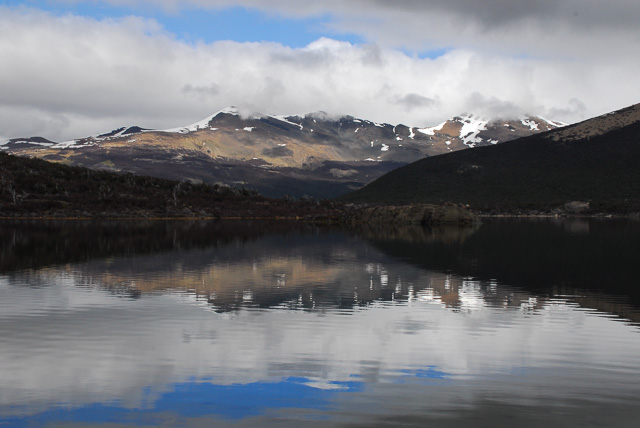 Snow-capped mountain with reflection in lake. Best Patagonia experiences.