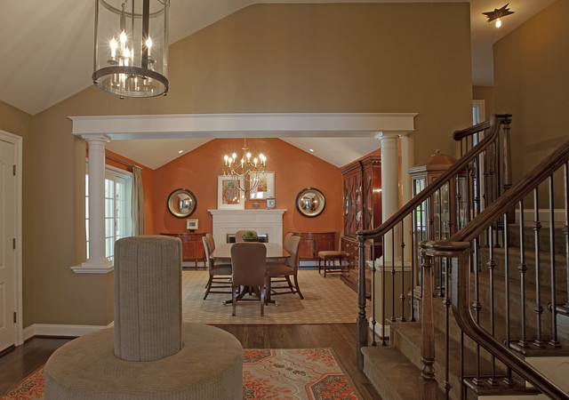 A khaki staircase leading to a dining room.