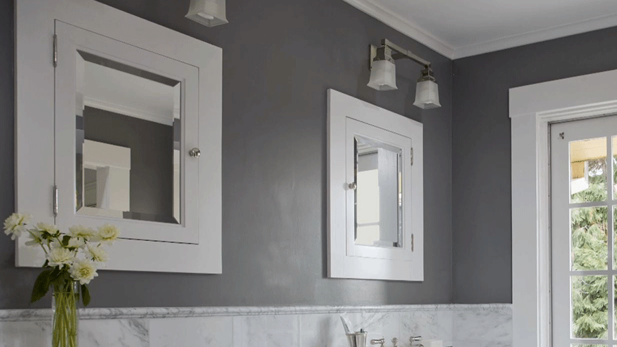 A bathroom makeover with gray walls and marble counter tops.