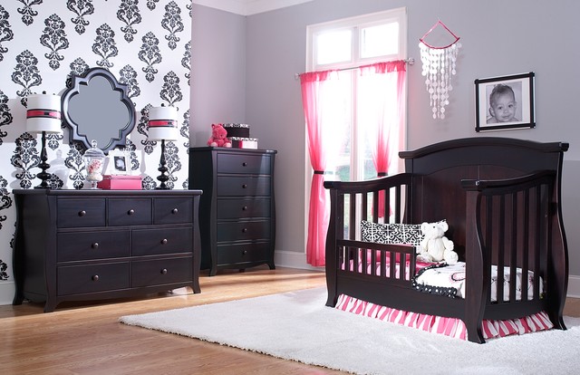 A black and pink nursery with a crib and dresser.