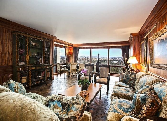 A living room with ornate furniture and a view of the city, featuring Cristiano Ronaldo memorabilia.