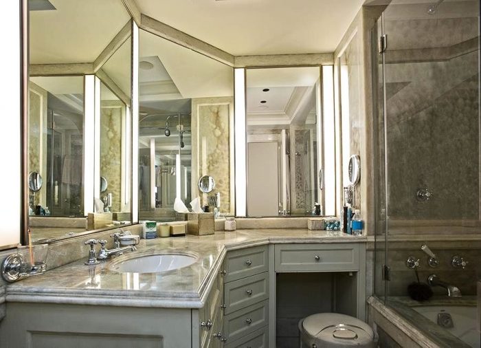 A bathroom with a large mirror and sink featuring Cristiano Ronaldo's signature.