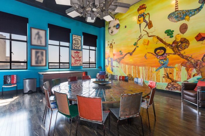 A dining room in Johnny Depp's Penthouse with a colorful mural on the wall.