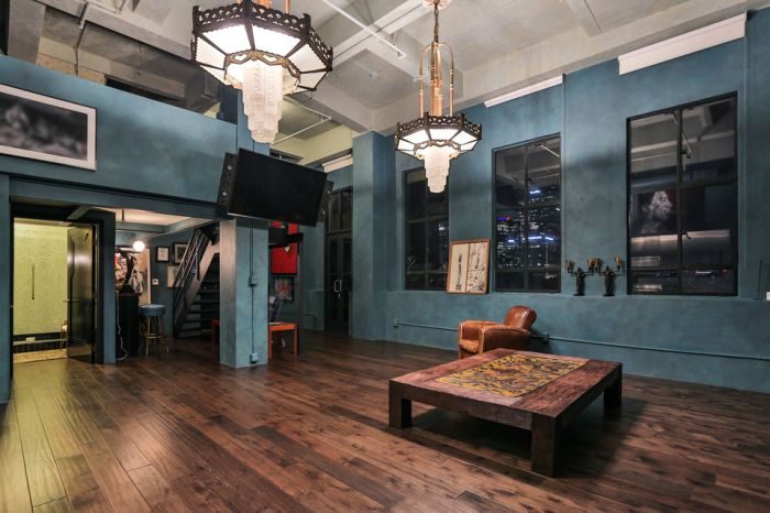 Johnny Depp's Penthouse decorated with blue walls and a wooden floor.