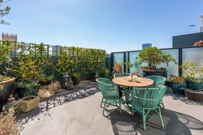 Johnny Depp's Penthouse featuring a rooftop patio with a table and chairs.