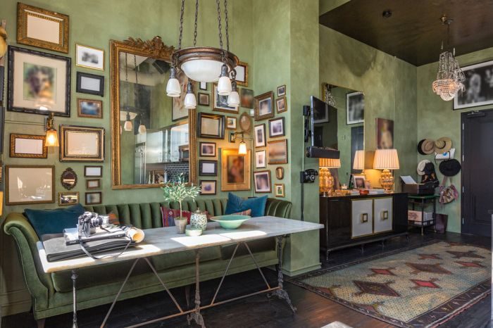 Johnny Depp's penthouse featuring a living room with green walls and framed pictures.