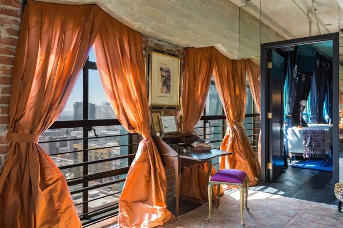 Johnny Depp's penthouse featuring city views and orange curtains.