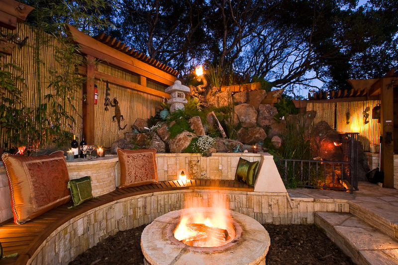 A fireplace in a garden at night.