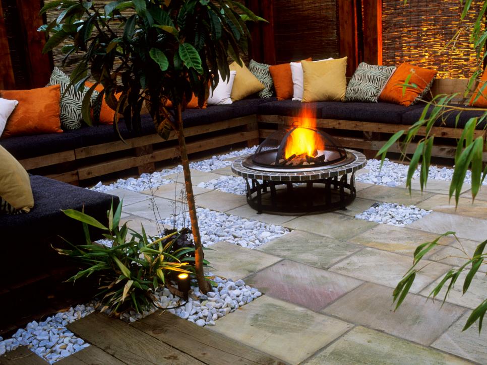 A patio with a fireplace and couches.