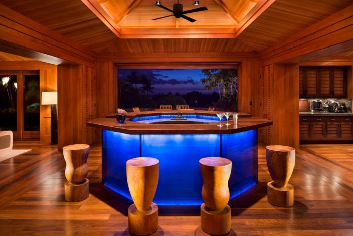A room with a wooden floor and a home bar.