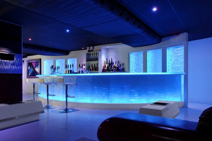 A home bar with blue lighting.
