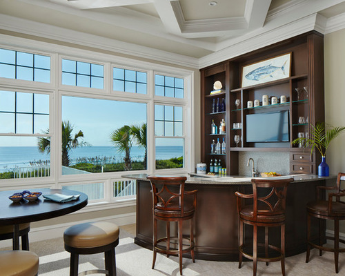 A home bar in a living room with a view of the ocean.