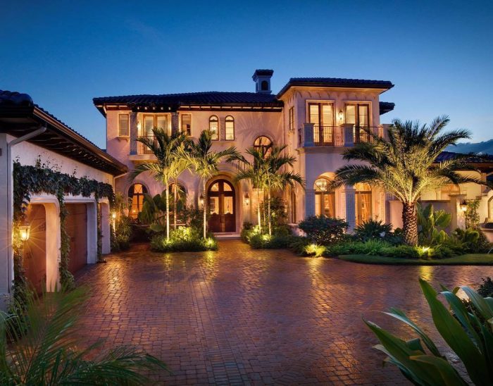 A luxurious Mediterranean style home at dusk.