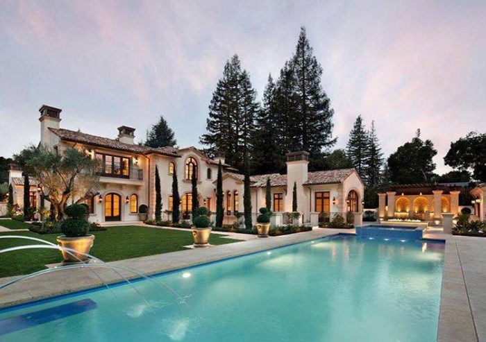 A luxurious mansion with a swimming pool.