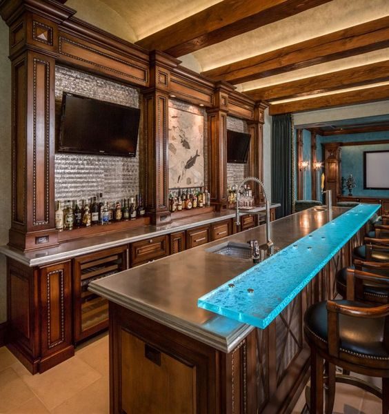 A modern home bar with a sleek glass top.