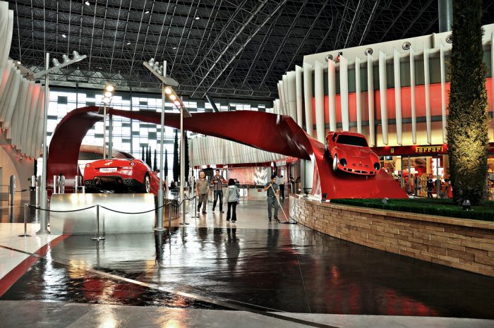 A red Ferrari car from Abu Dhabi is on display in a museum.