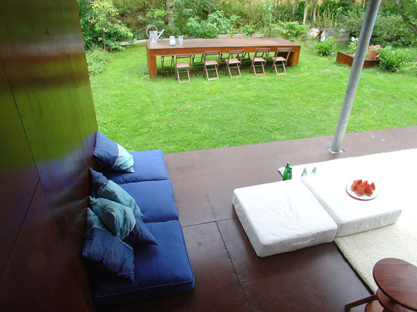 A wooden deck with a table and chairs at a Norwegian home.