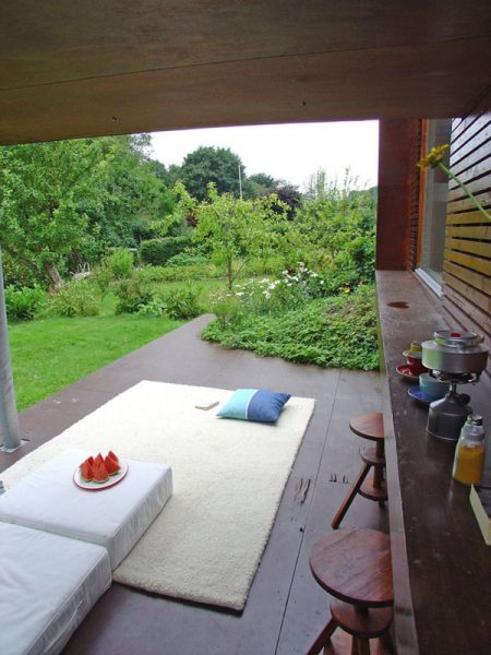 A white rug on a wooden deck in a Norwegian home.