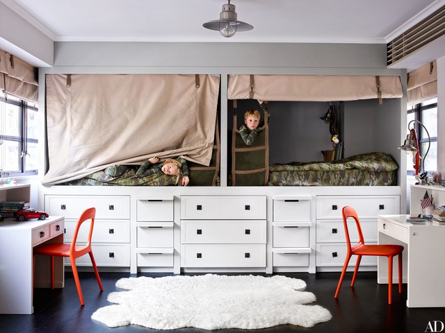 A child's room with a bunk bed and a desk.