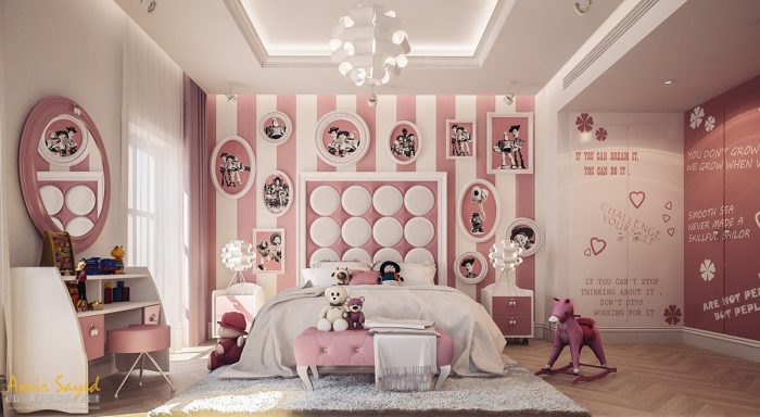 A child's pink and white bedroom with pictures on the walls.