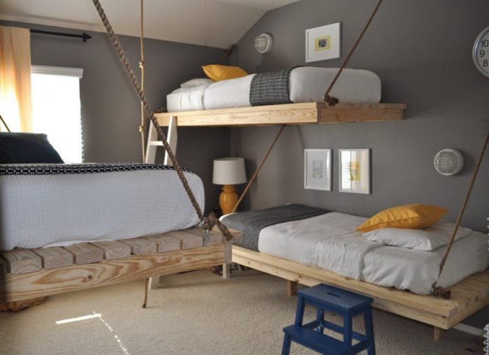 A child's room with two bunk beds hanging from the ceiling.