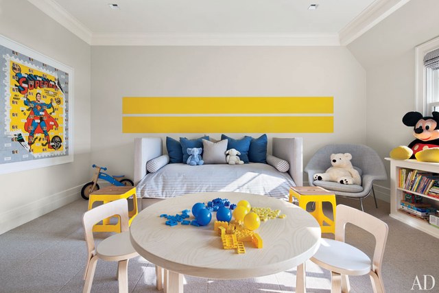 A child's room with yellow furniture and toys.