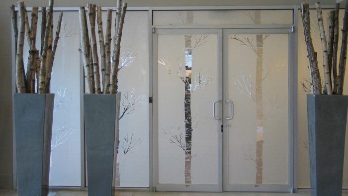 A glass door with two vases.