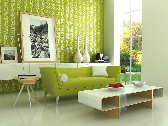 A living room with Pantone's green walls and a white couch.