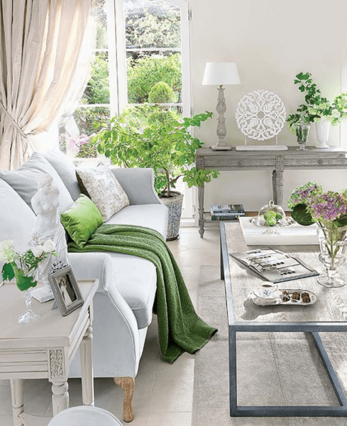 A living room with Pantone's white furniture and green plants.
