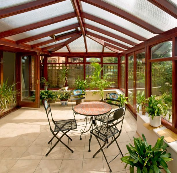 A sunroom with a table and chairs.