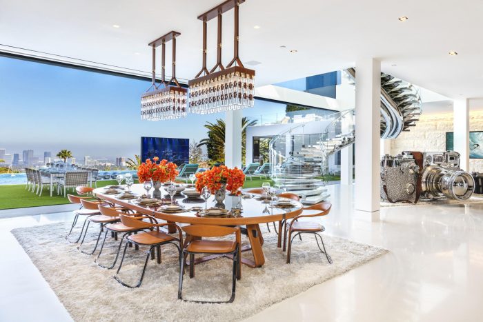 A dining room with a large glass table and chairs located at 924 Bel Air Rd.