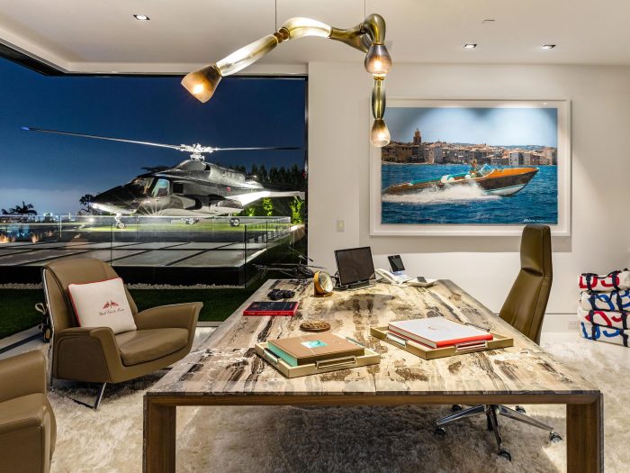 A luxurious home office with a desk and a helicopter, located at the prestigious 924 Bel Air Rd.