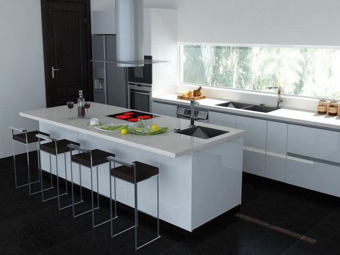 A black and white kitchen with stools.