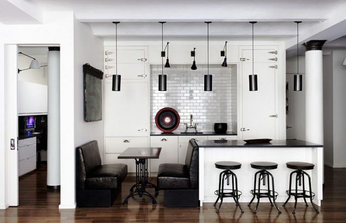 A monochrome kitchen with bar stools.