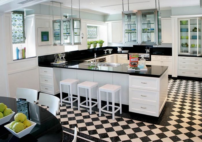 A black and white kitchen with a checkered floor.