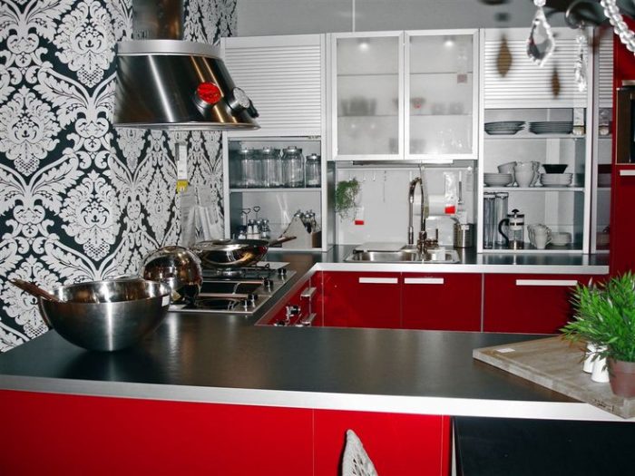 Look at how the red kitchen cabinets pop against the black &amp; white color scheme.