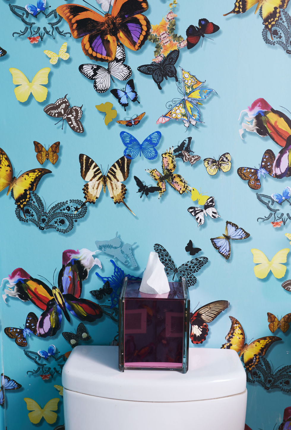 A bathroom with colorful butterflies on the wall, showcasing 2017 interior trends.