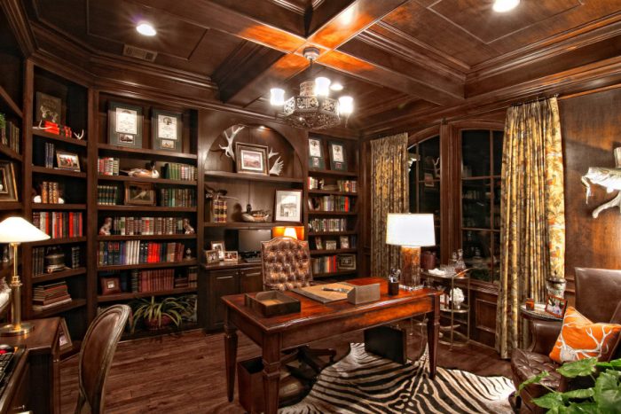 This luxurious home office features a wall of shelving.