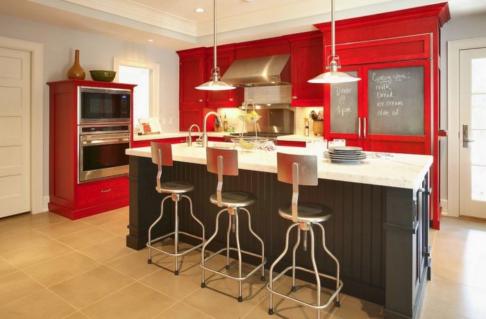 A modern kitchen with red cabinets.