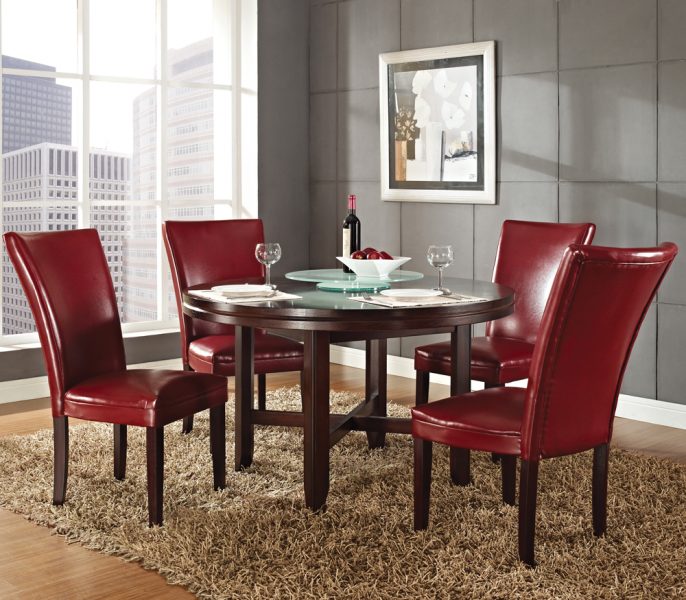 A modern dining table with red leather chairs.