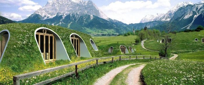 A Hobbit home made of grass in the middle of a mountain.