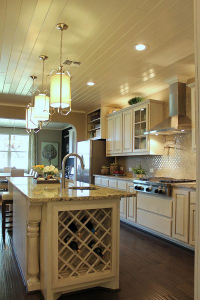 A kitchen featuring a spacious island and wine storage.