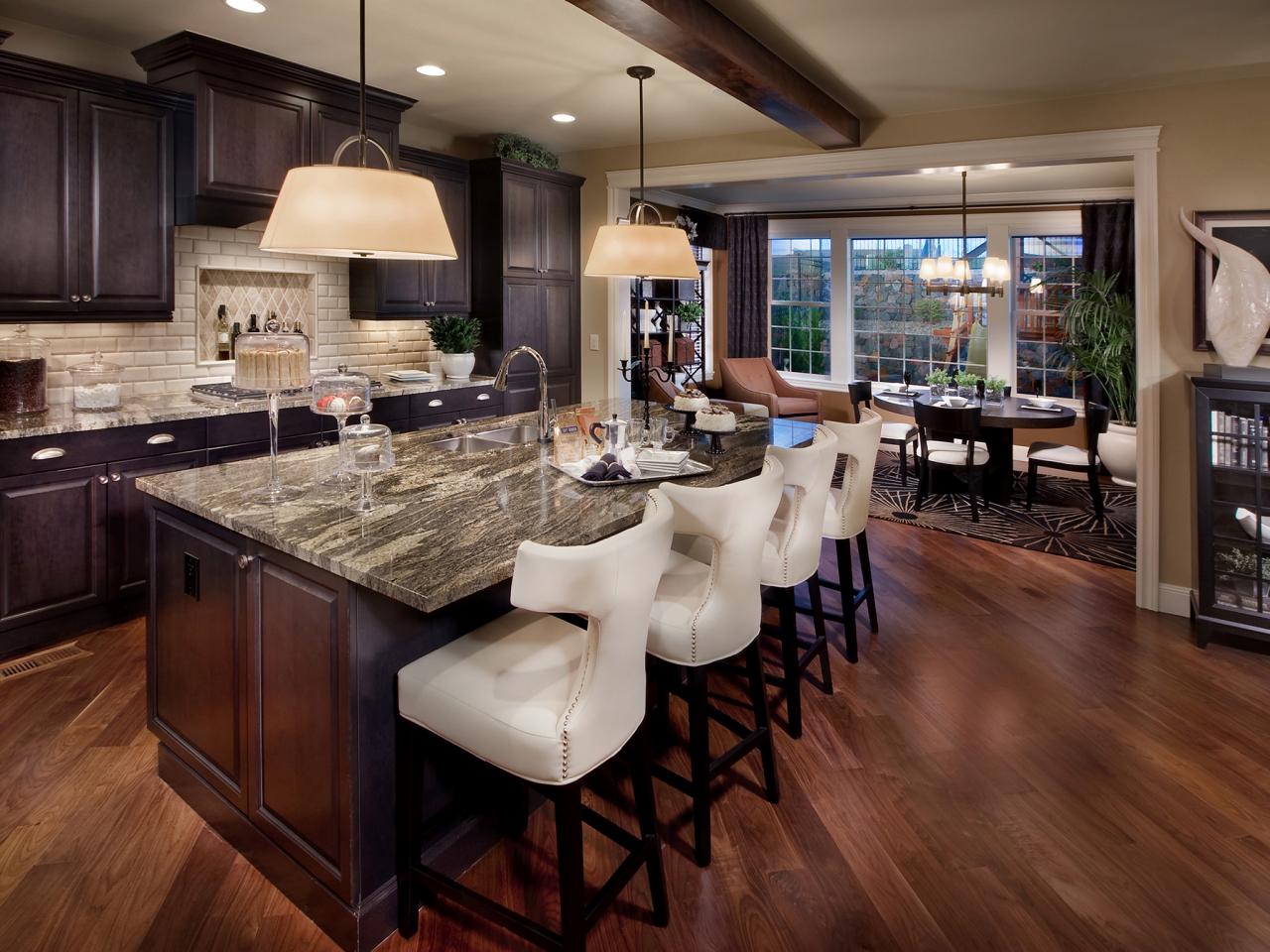 A kitchen with a center island and dark wood cabinets.