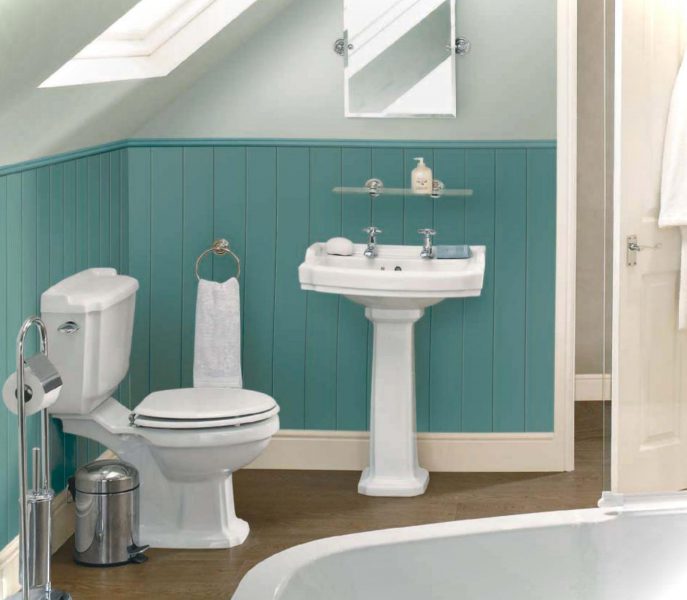 A bathroom with blue walls and a white toilet equipped with mirrors.