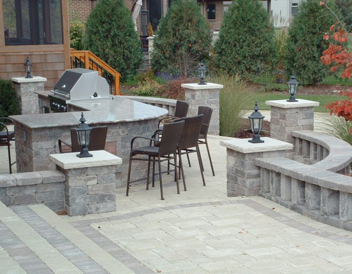 A patio for entertaining with a grill and seating area.