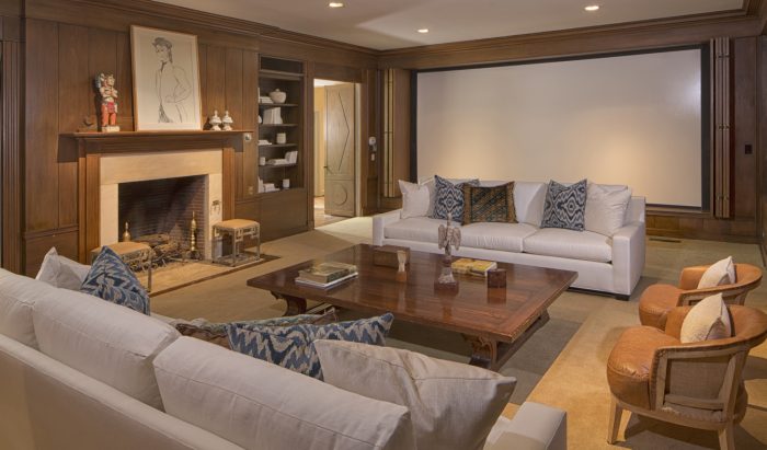 A living room with couches and a fireplace in Taylor Swift's home.