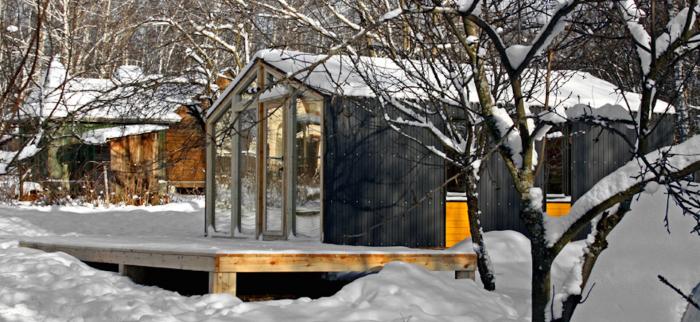 A small cabin in the snow, featuring top 15 tiny house designs and floor plans.