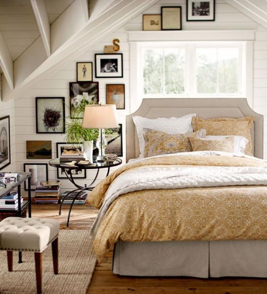A rustic bedroom with farmhouse touches featuring a bed and bedside table.