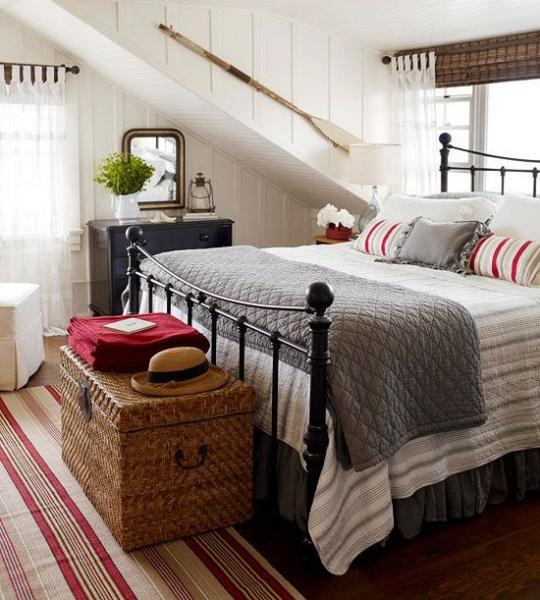 A bedroom with rustic farmhouse touches and striped rugs.