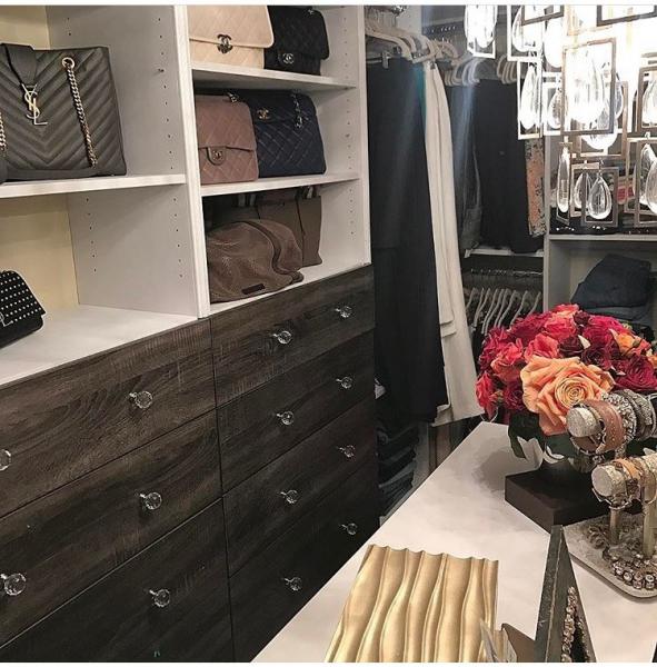A walk-in closet with minimal clutter and lots of jewelry and purses.